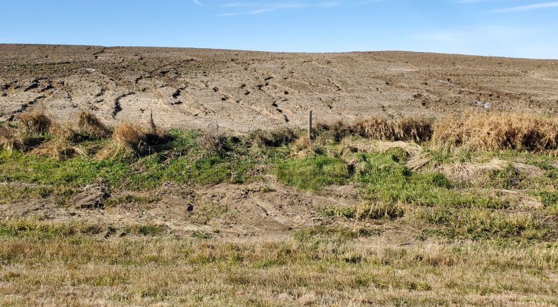 Sheet and rill erosion located near the Sioux Falls area. Sheet erosion occurs when a thin layer of topsoil is removed over a hillside field – and may not be readily noticeable. Rill erosion occurs when runoff water forms small channels as it flows down a slope. This type of soil erosion can be avoided by maintaining a protective cover on the soil and modifying the landscape to control runoff amounts and rates. Sheet and Rill Erosion